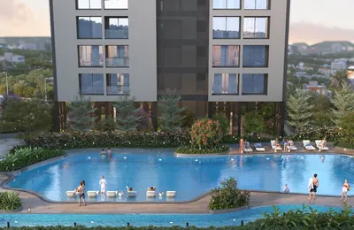 Leisure pool and sun deck with loungers below the residential towers at ANP Privado