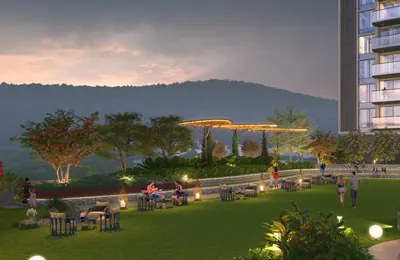 Leisure lawn with seating and a lit pergola at dusk, hills behind, at ANP Privado